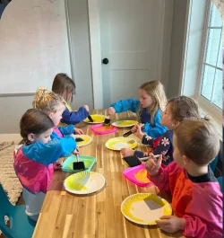 Blissful Beginnings students creating projects together at the classroom table